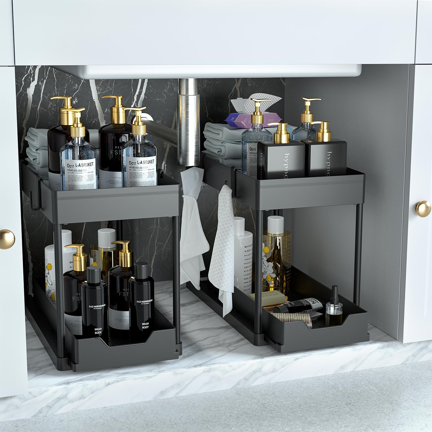DEKAVA 2-pack black under sink organizers featuring a 2-tier design with sliding storage drawers, shown holding bathroom toiletries and cleaning supplies inside a marble-lined cabinet.